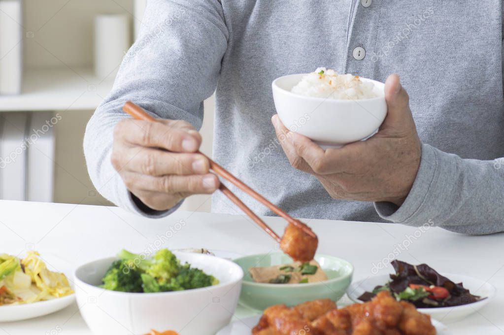 man holding a bowl of food