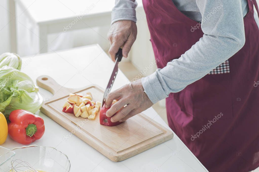 man cooking vegetables at the table at home
