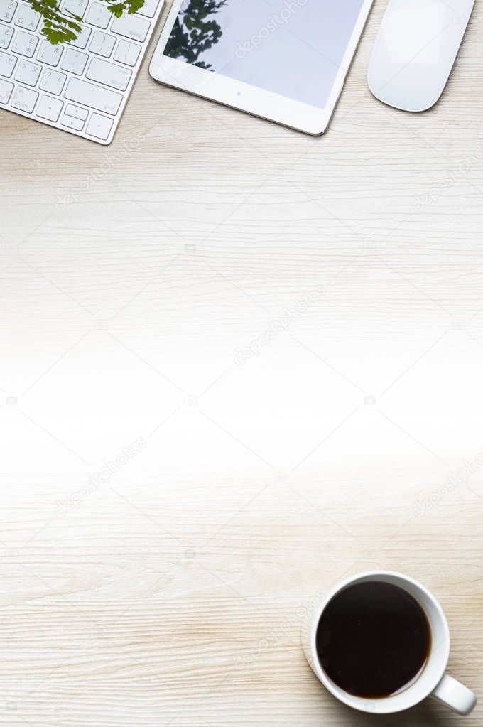 cup of coffee and tablet pc on wooden table