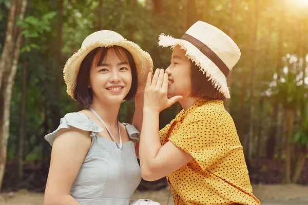 Shot Two Smiling Girls Whispering Secret Ear Park Outdoors Friendship — Stock Photo, Image