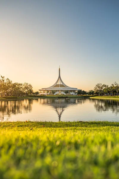 Suan Luang Rama IX (Rama 9) public park with evening sunlight and green lawn in foreground (Bangkok, Thailand)