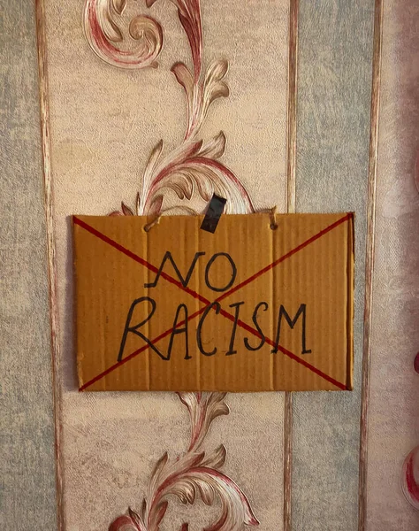 No racism poster hanging on wall.