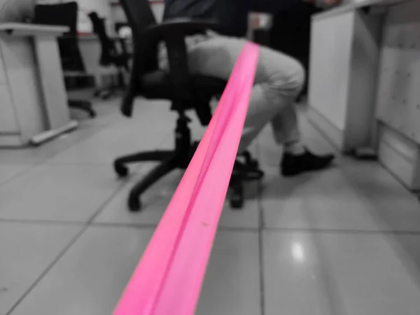 Social distancing maintained in office between customer and employee by putting ribbon.