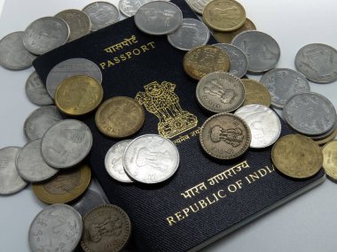 Beyaz masada üzerinde rupi olan Hint pasaportu resmi.