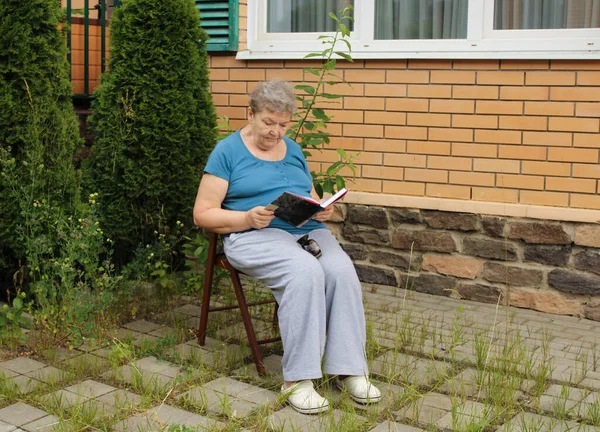 Elderly Woman Sitting Courtyard Summer Day Reading Book Concept Happy Stock Picture