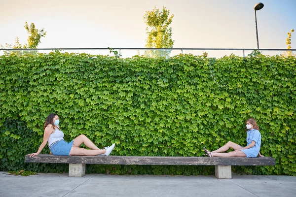 Zwei Freunde Sitzen Einem Park Mit Maske Für Covid Sie — Stockfoto