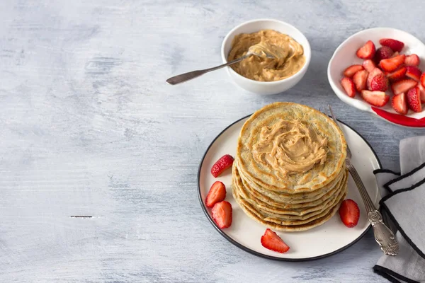 Vegan pancakes with flax seeds, peanut butter, strawberry and vegan milk