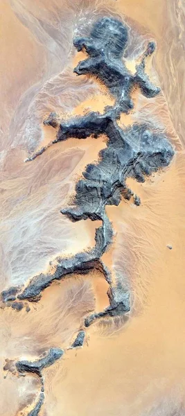 the skeleton of the warrior, vertical abstract photography of the deserts of Africa from the air, aerial view of desert landscapes, Genre: Abstract Naturalism, from the abstract to the figurative, ,
