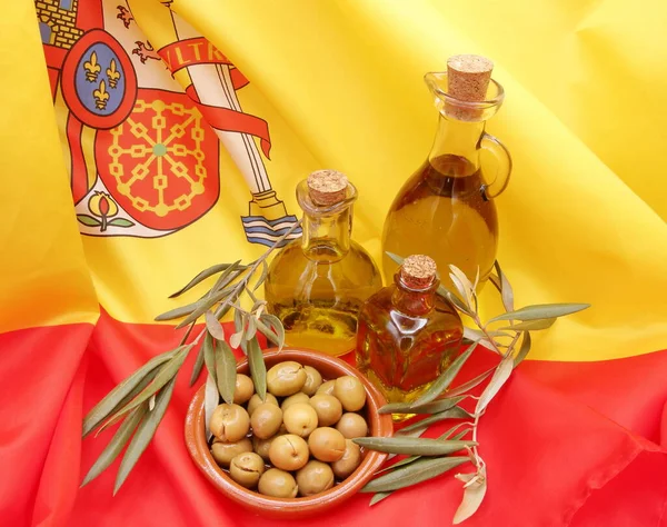 Products from Spain, split green olives, Alorena variety, with different glass bottles with and olive branches on the flag of Spain, product photo, the best natural medicine,