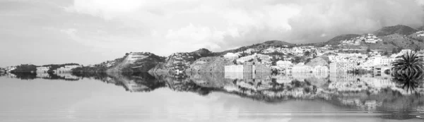 The beginning of the end,  climate change does not exist, phrase of D.Trump, dystopian photography black and white photograph of Almunecar, Spain, flooded by the rising sea waters,