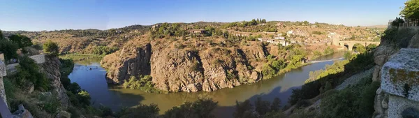 世界遺産のトレドを流れるタガス川の崖の上には シガレールが見えます — ストック写真