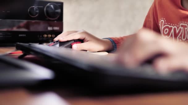 Boy Plays Computer Games Using Mouse Keyboard — Stock Video