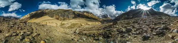 Scenic panorama of sun setting behind mountains in Kashmir, India