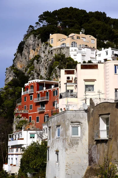 The Isle of Capri in the Bay of Naples has been a holiday resort since the time of the Romans when Emperor Tiberius built a villa there. Buildings cling to its steep sides