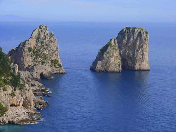 The iconic Faraglioni Rocks off the island of Capri in Italy. The shape of these unique rocks identify the Isle of Capri in th Bay of Naples in Italy