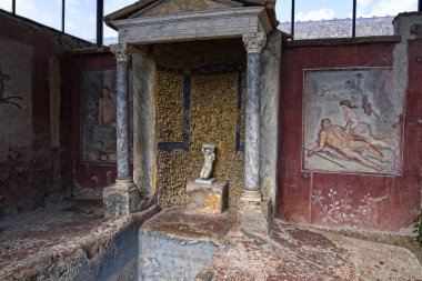 Frescoes in a villa in the once buried Roman city of Pompeii south of Naples under the shadow of Mount Vesuvius also near Naples in Italy clipart