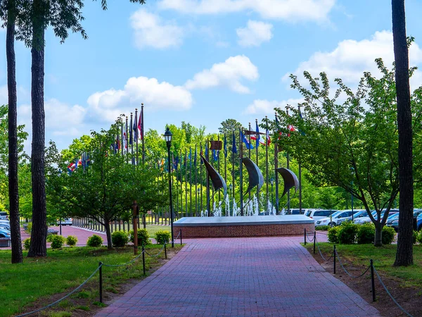 stock image Flags and memorial at Historic Jamestown on the James River where the earliest European settlers established their first colony in Virginia USA