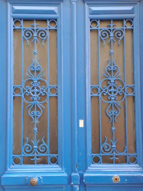 old wooden door with window and blue paint
