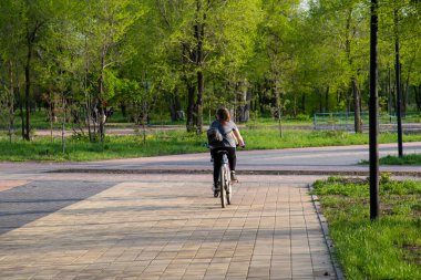 Yazın parkta bisiklet süren kızlar..
