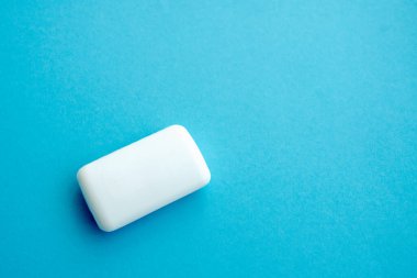 Beyaz sabun, mavi fotokopi arkaplanda izole edilmiş. Düz katman. Üst görünüm.