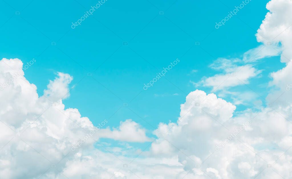 light blue sky with bright soft clouds