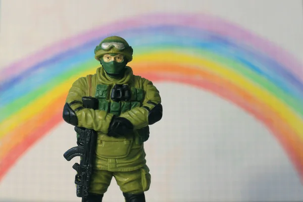 toy soldier on the background of a painted rainbow