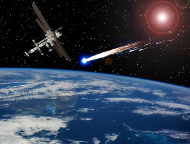 Dünyanın üstündeki uzay istasyonu. Meteorlar, uzaydaki kuyruklu yıldız. Ele
