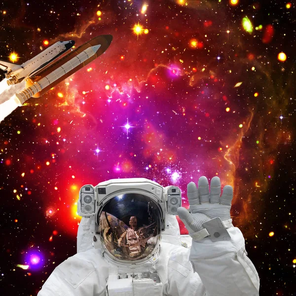 Astronaut posing. Rocket on the backdrop. The elements of this i