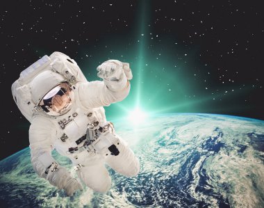 Dünya üzerinde gün doğumu. Astronotuzay yürüyüşü. Elemanları 
