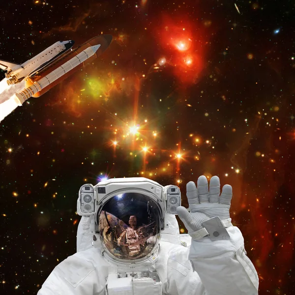 Astronaut posing. Rocket on the backdrop. The elements of this i