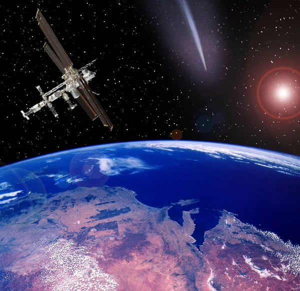Space station above the earth. Meteors, comets in space. The ele — Stock Photo, Image