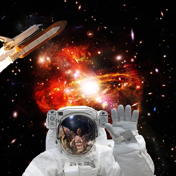 Astronaut posing. Rocket on the backdrop. The elements of this i