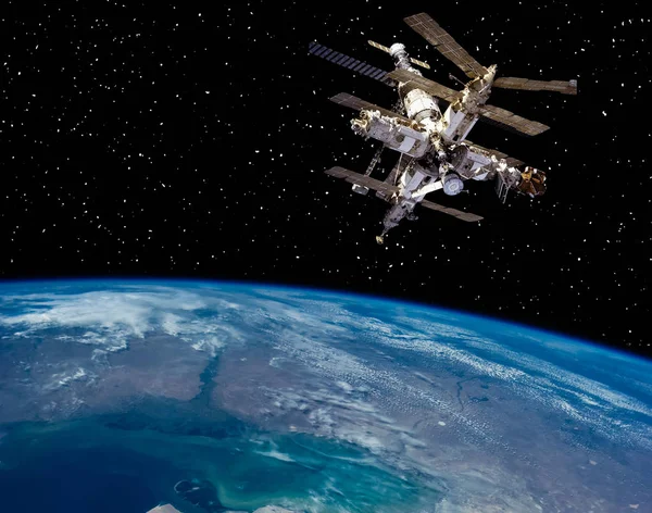 Earth and space station. The elements of this image furnished by — Stock Photo, Image