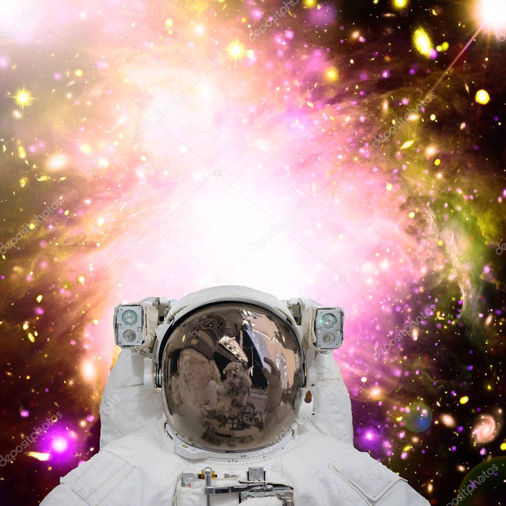 Closeup of astronaut. Galaxy on the background. The elements of 