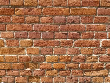 Kırmızı antika tuğla dokusu. Eski kırmızı tuğla duvar dokusunun arka planında yaştan sonra bozulma var. Tuğla duvar parlak güneş tarafından aydınlatıldı..