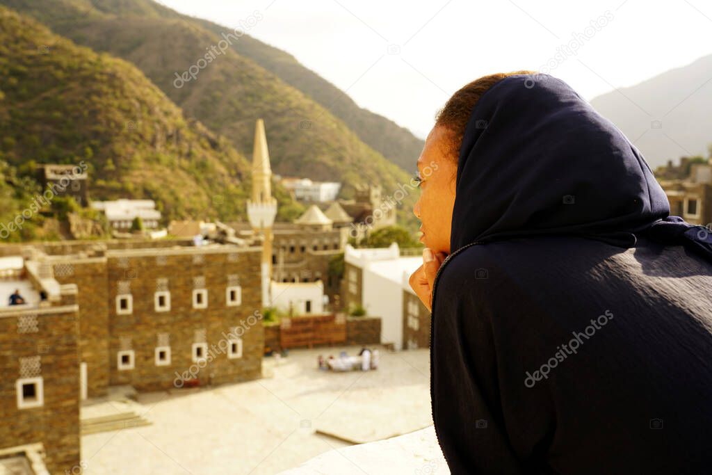 Back young muslim woman close up portrait in historical old village