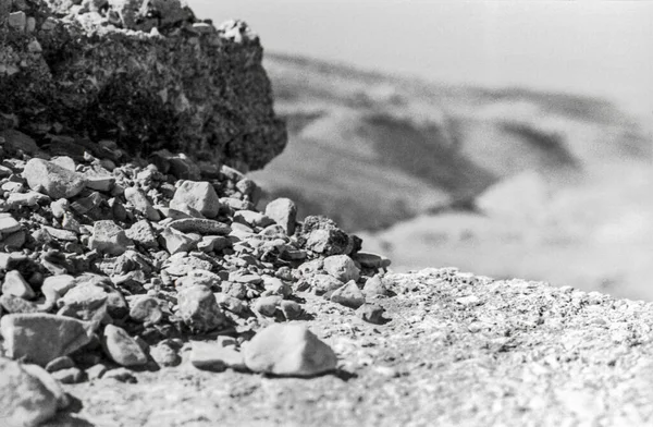 A pile of stones and a view of the desert