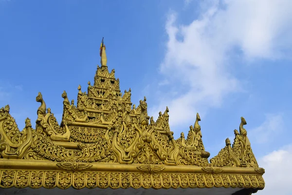 Budist tapınağının tepesinde muhteşem mimari altın pagoda. Mavi gökyüzü ve Budist manastırı.