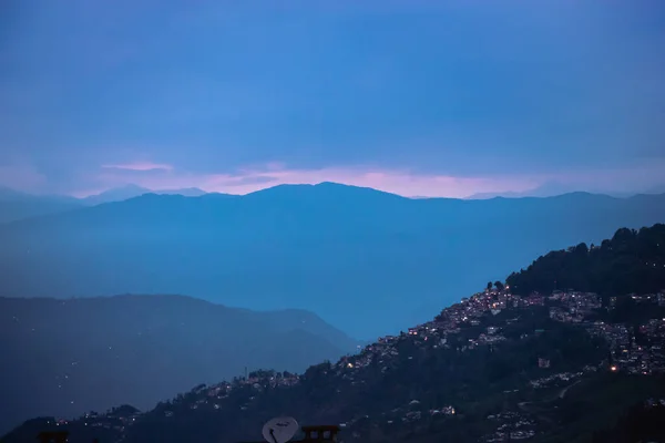 Darjeeling 'in akşam vakti. Şehrin her yerinde binlerce ışık yanıp sönüyor. mavi ufuk dağ zirvesi