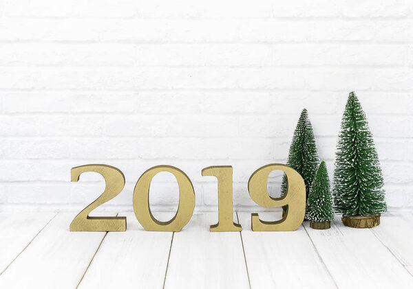2019 new year and christmas tree on white wood table over white background with copy space