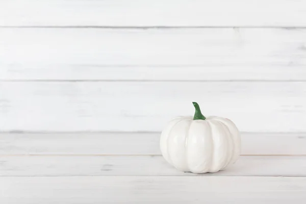 White pumpkin on white wood table with copy space.