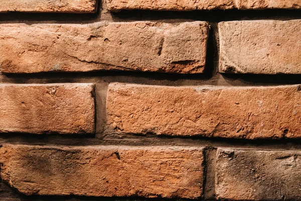 brick texture wall of red, natural, old, battered brick. close-up pattern. wall decoration in the interior of the loft