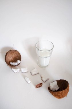 Bir bardak hindistan cevizi sütü. Hindistan cevizi doğranmış. Beyaz arka plan. Boş alan