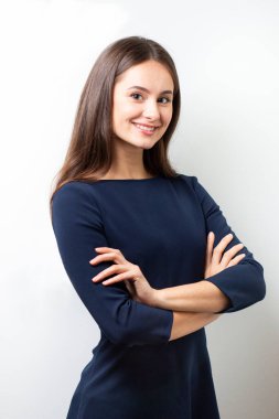 Beyaz arka planda mavi ofis elbisesi giymiş bir kadının iş portresi. Kendine güveni tam bir kadının kameraya bakarken çekilmiş iş fotoğrafı..