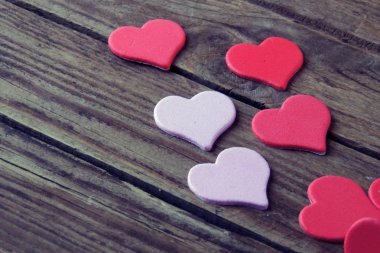 Ahşap beyaz arka plan, kırmızı kalpler, hediyeler ve mumlar. Sevgililer Günü konsepti.