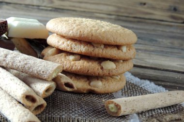 Ahşap üzerine çift çikolatalı kurabiye. kurabiye ve tatlı tüpler