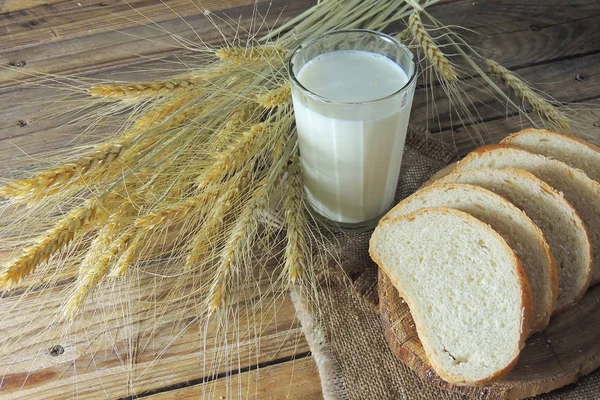 White bread and jug of milk on linen texture