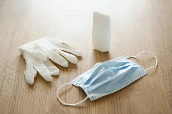 Protective devices to go out your house safely during the viral emergency, pandemic caused by Coronavirus (COVID-19): disposable surgical mask, latex gloves and hand sanitizer gel.