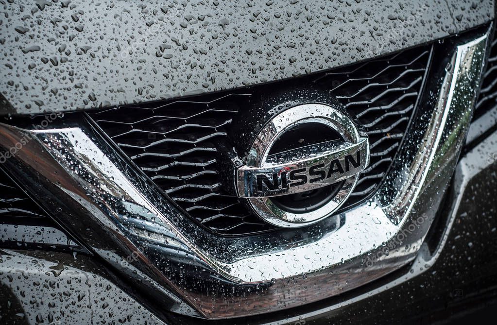 Mulhouse - France - 16 May 2018 - Closeup of rain drops on Nissan logo on black 4X4 car front