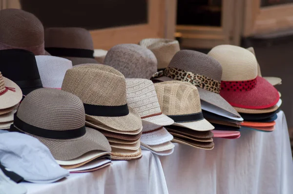 closeup of summer hats collection at the market